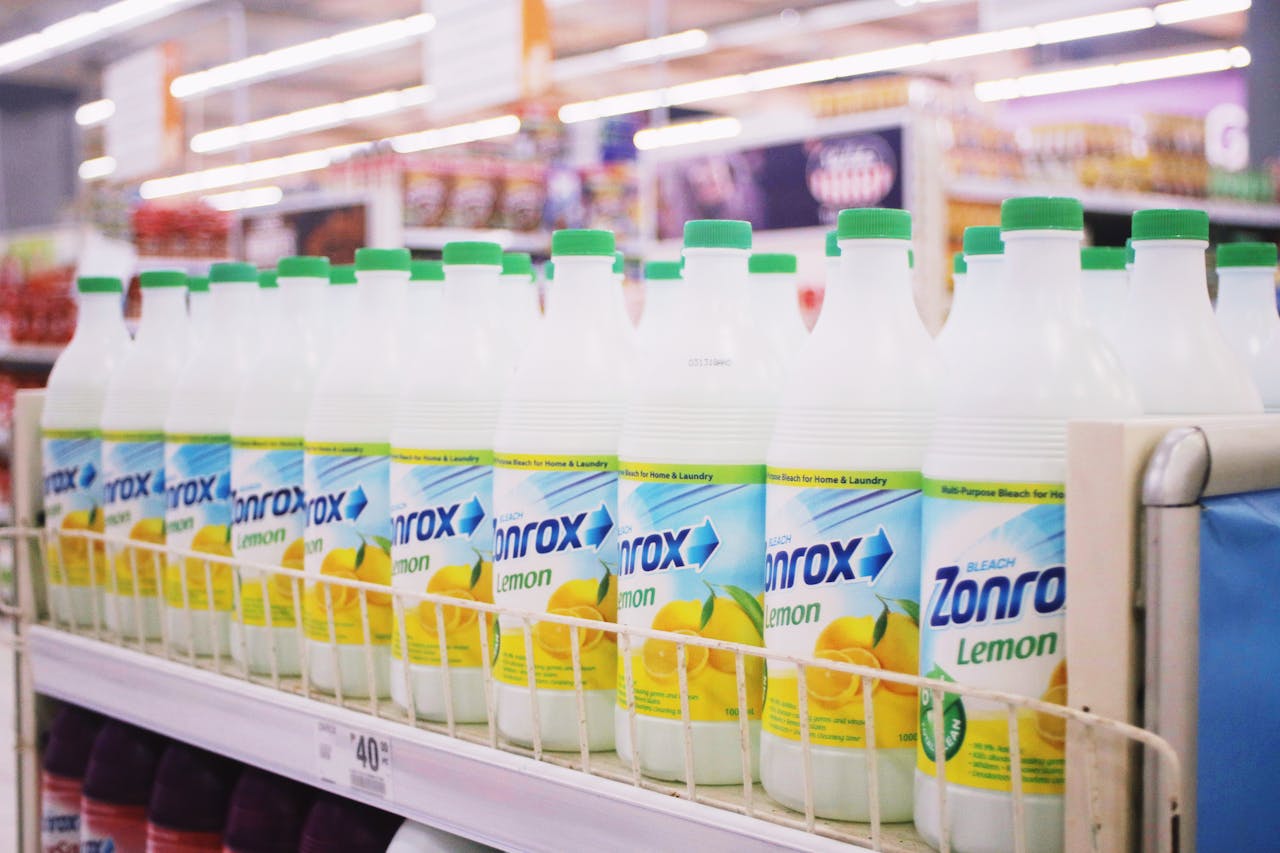 services-01 Rows of plastic bottles of bleach with smell of lemon placed on shelves in supermarket